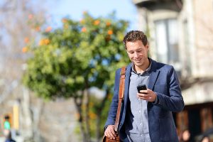 young-urban-professional-man-using-smart-phone-businessman-hold