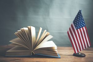 composition-of-american-flag-and-book-on-table