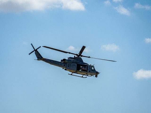 army-helicopter-hovering-on-a-blue-sky-background-helicopter-on