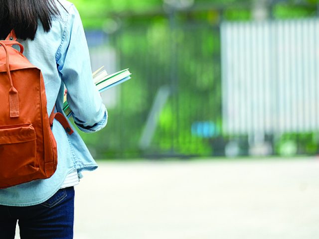 back-of-university-student-with-backpack-while-going-to-college