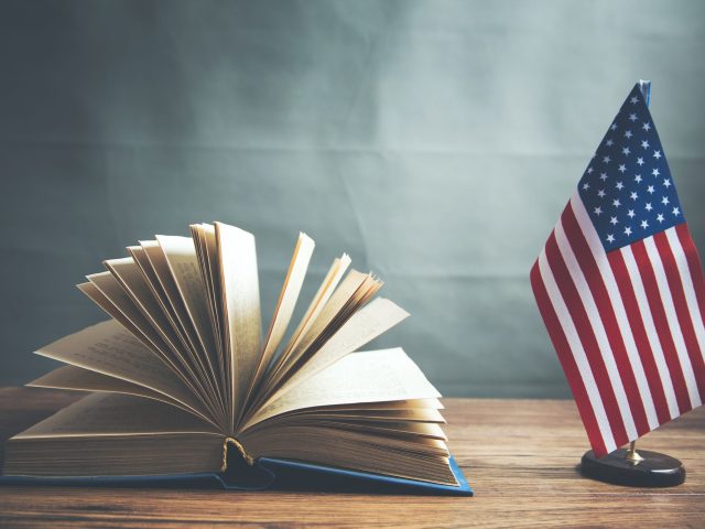 composition-of-american-flag-and-book-on-table